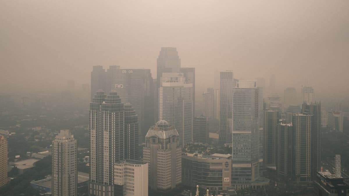 City skyline obscured by dense smog and air pollution haze